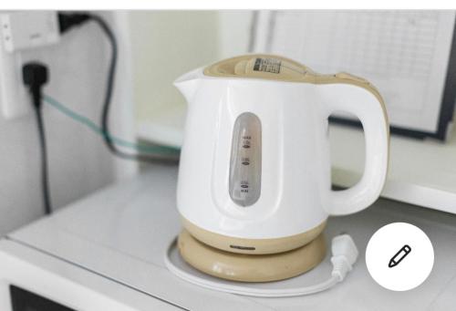 a white mixer sitting on top of a counter at Ikebukuro Florence Hostel in Tokyo
