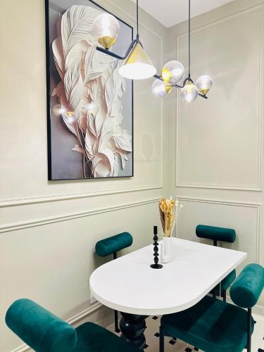 a dining room with a white table and blue chairs at Afidea Homestay Kids Friendly Condo In Nilai-Netflix,Game in Nilai