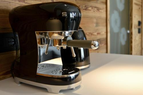 a coffee maker is sitting on a counter at Origini Holidays in Sedico