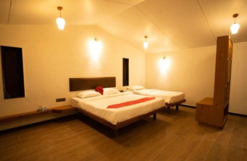 a bedroom with two beds in a room at Bliss Nirvana Resort in Lonavala