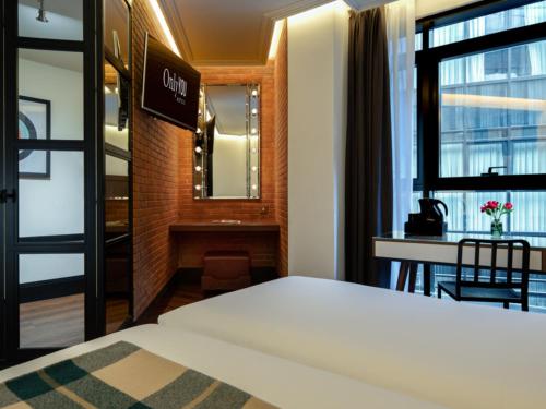 a hotel room with a bed and a desk at Only YOU Hotel Atocha in Madrid
