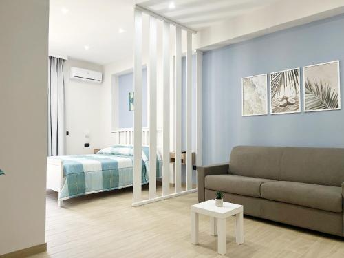 a living room with a couch and a bedroom at Blue Diamond in Vibo Valentia Marina
