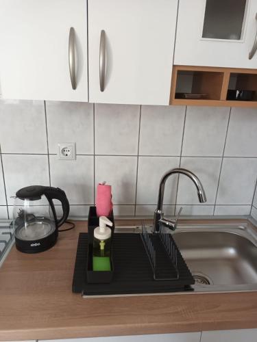 a kitchen counter with a sink and a faucet at kutak in Sesvete