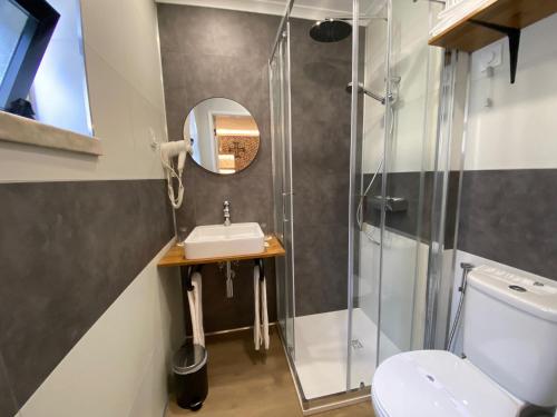 a bathroom with a sink and a shower at Hotel Cavaleiros De Cristo in Tomar