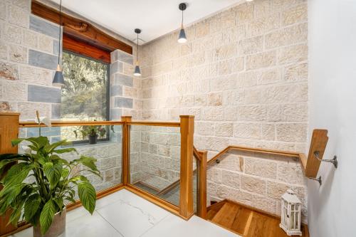 a room with a stone wall and a window at Villa Celestia in Zakynthos Town