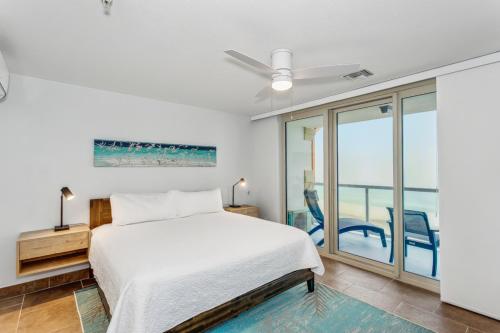 1 dormitorio con 1 cama y puerta corredera de cristal en Beach Club Resort and Spa en Pensacola Beach