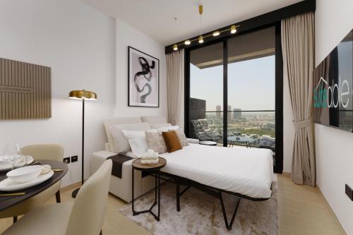 a bedroom with a bed and a table and a dining room at Experience Serenity at Binghatti Crest in JVC in Dubai