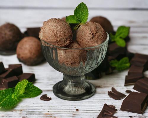 a bowl of chocolate truffles with mint on a table at VinoOdor - ვინოოდორ in Tʼelavi