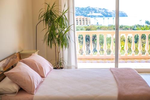a bedroom with a bed and a large window at Casa Crisana in La Herradura