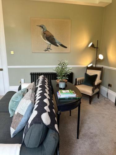 a living room with a couch and a table at The Beeches - Chatsworth Apartment No 2 - Sleeps 4 in Baslow