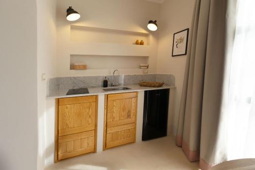 a kitchen with a sink and a counter at Al Poggiale - Residenza Mediterranea in Porto Cesareo