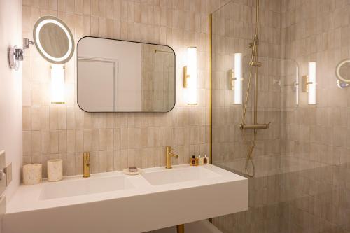 a bathroom with a sink and a mirror at Lou Cagnard in Saint-Tropez