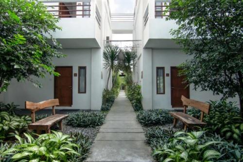two benches in the courtyard of a building at Diva Lombok Resort in Senggigi 