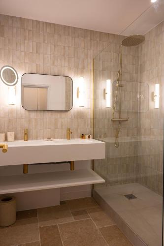 a bathroom with a sink and a mirror at Lou Cagnard in Saint-Tropez