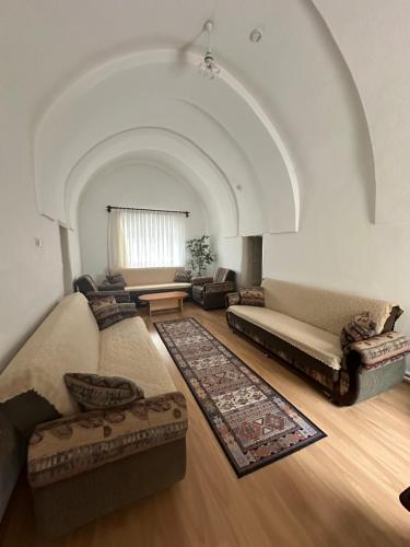 a living room with two couches and a table at Ayten Hanım Konağı in Ürgüp