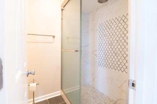 a shower with a glass door in a bathroom at Oceanfront and Modern Top Location on Ocean Blvd w Pool in Myrtle Beach
