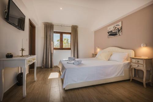 a bedroom with a bed and a desk and a television at Rooms with Breakfast near Porec in Nova Vas