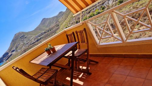 a balcony with a table and chairs and a mountain at Cabo de Palos Apartment in Cabo de Palos