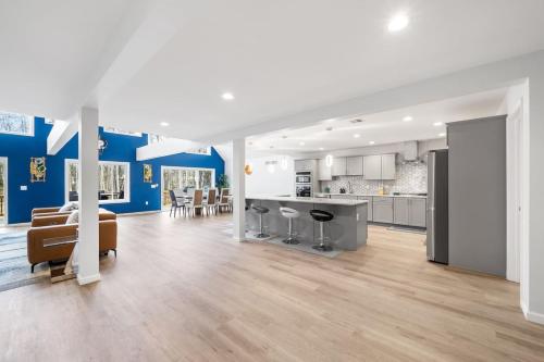 an open living room and kitchen with blue walls at Big Villa,4 Masters, Heated Pool, Hot Tub, Sauna in Blakeslee