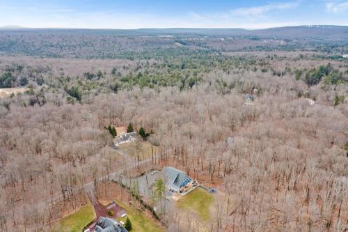 an aerial view of a house in the woods at Big Villa,4 Masters, Heated Pool, Hot Tub, Sauna in Blakeslee