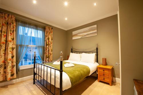 a bedroom with a bed and a window at Clifford House - 4 Bed Home Within The City Walls in York
