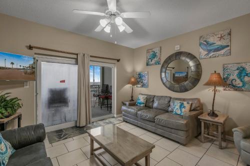 a living room with a couch and a ceiling fan at Tradewinds 001 by Vacation Homes Collection in Orange Beach