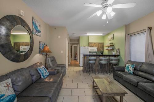 a living room with a couch and a table at Tradewinds 001 by Vacation Homes Collection in Orange Beach
