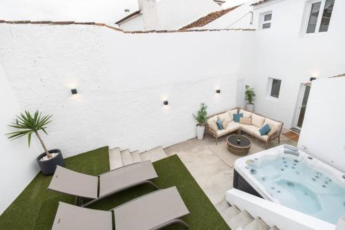 a rooftop patio with a hot tub in a building at NEW! Oceanfront Home with HotTub, Lagoa Sao Miguel Azores in Lagoa