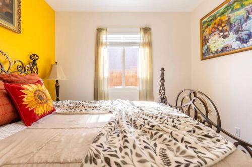 a bedroom with a large bed and a window at Desert Sun Flower: Private Spa, pool, Golf area in Coachella