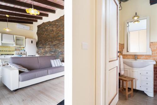 a kitchen and a living room with a couch and a sink at casa Luna in Dorgali