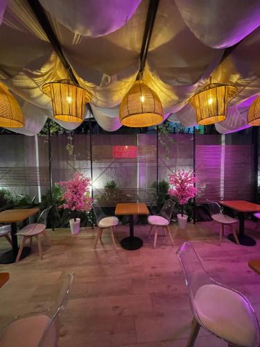 a large room with tables and chairs and lights at Aurora Smart Residence, Wuse 2, Abuja in Abuja