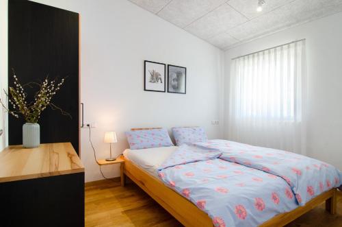 a bedroom with a bed and a desk in it at Ferienwohnungen Walz in Pfullendorf