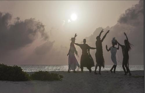 a group of people dancing on the beach at Palmaïa The House of AïA All Inclusive Wellness Resort in Playa del Carmen