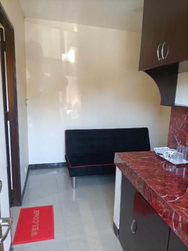 a kitchen with a black bench in a room at Parkdale apartment in Imus