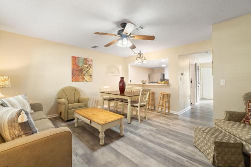 a living room with a couch and a table at Gulf View 16 by Vacation Homes Collection in Gulf Shores