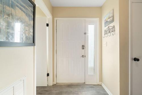 a hallway with a white door in a house at Gulf View 16 by Vacation Homes Collection in Gulf Shores