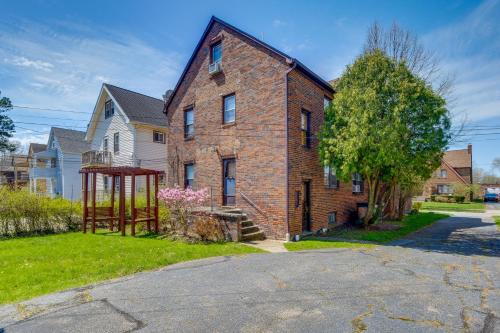 an old brick house with a playground in the yard at South Euclid Apt Less Than 10 Mi to Downtown Cleveland! in South Euclid