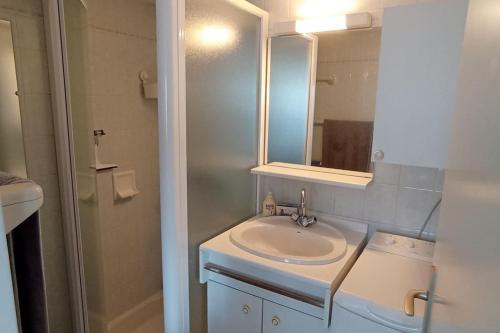 une salle de bain avec un lavabo, un miroir et une douche dans l'établissement La Grière résidence avec piscine, à La Tranche-sur-Mer