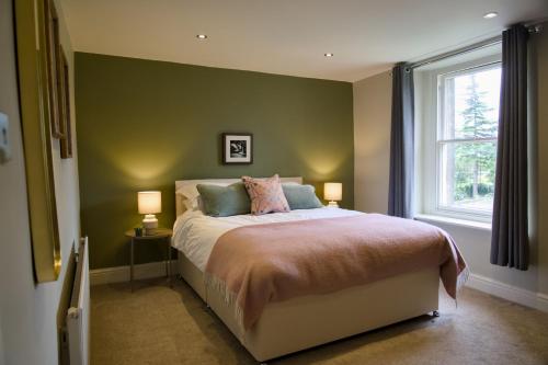 um quarto com uma cama com 2 candeeiros e uma janela em The Beeches - Chatsworth Apartment No 3 - Sleeps 2 em Baslow