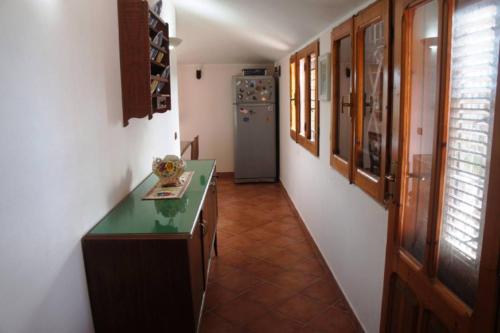 a kitchen with a green counter and a refrigerator at VILLA CATERINA in Calasetta