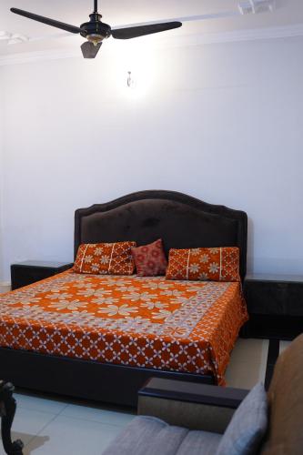 a bed with pillows on it in a room at Mohal's House in Lahore