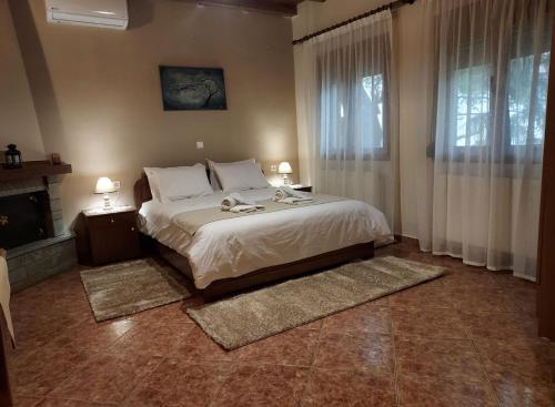 a bedroom with a large bed and a fireplace at Guesthouse Platon in Órma