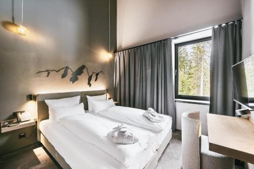 Postel nebo postele na pokoji v ubytování TRIFORÊT alpin resort