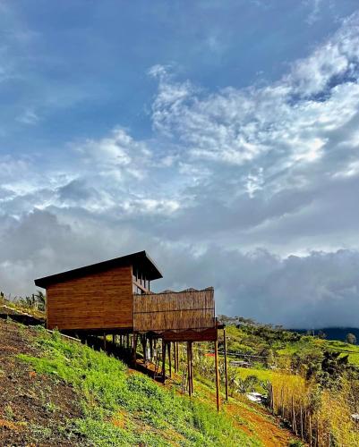 a small building on the side of a hill at Entre Nubes Eco Hotel in El Queremal