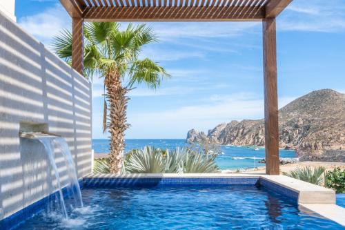 a swimming pool with a view of the ocean at 1 Homes Preview Cabo in Cabo San Lucas