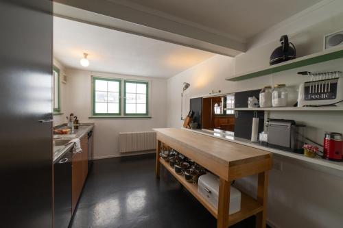 a large kitchen with a wooden counter in it at Chammern in Nesslau