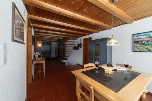 a kitchen with a table and glasses of wine at Chammern in Nesslau