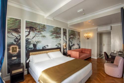 ローマにあるヴィヴァルディ ラグジュアリー ルームズのベッドルーム1室(ベッド1台付)が備わります。壁には絵画が飾られています。