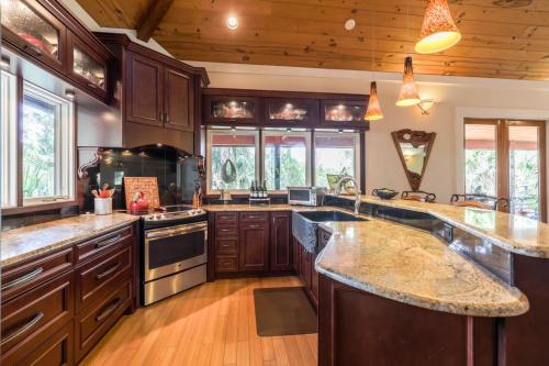 a large kitchen with wooden cabinets and granite counter tops at Taste of the Tropics in Saint Augustine