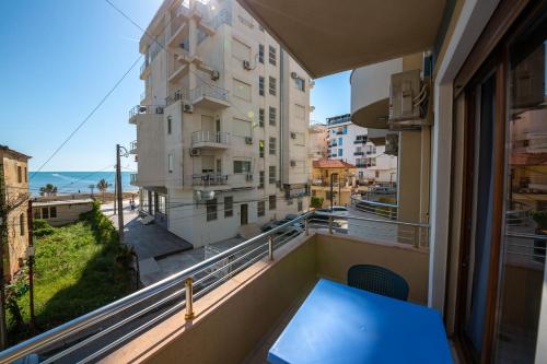 a balcony with a table and a view of a building at Hotel Vila Misiri in Durrës